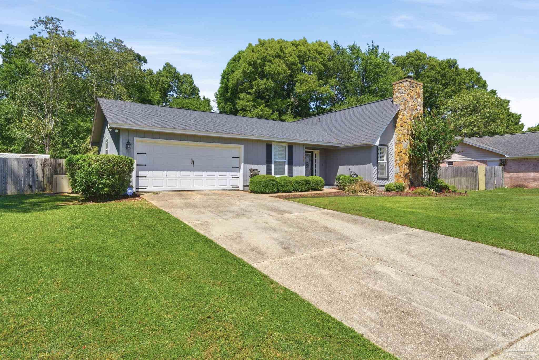 934 Springmier Place Pensacola, FL 32514 - Photo 2 of 49 a front view of a house with a yard and trees