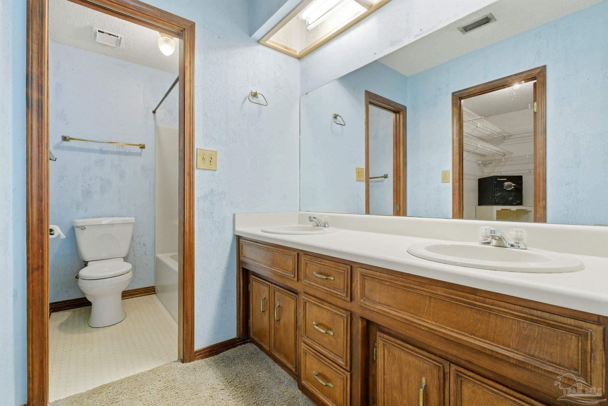 934 Springmier Place Pensacola, FL 32514 - Photo 22 of 49 a spacious bathroom with a granite countertop sink mirror and toilet