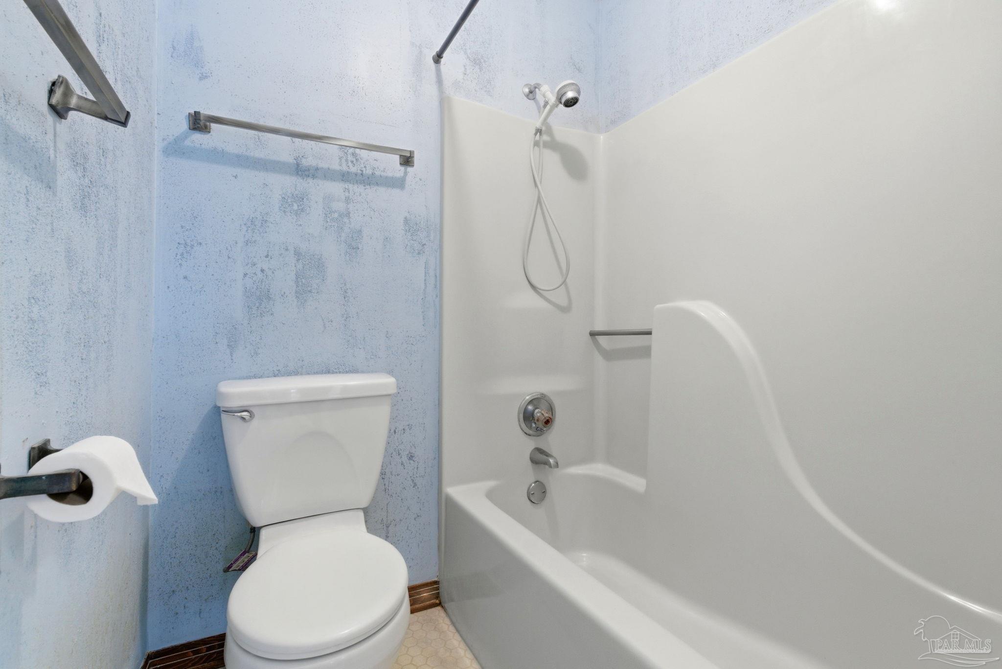 934 Springmier Place Pensacola, FL 32514 - Photo 23 of 49 a white toilet sitting next to a bath tub and shower