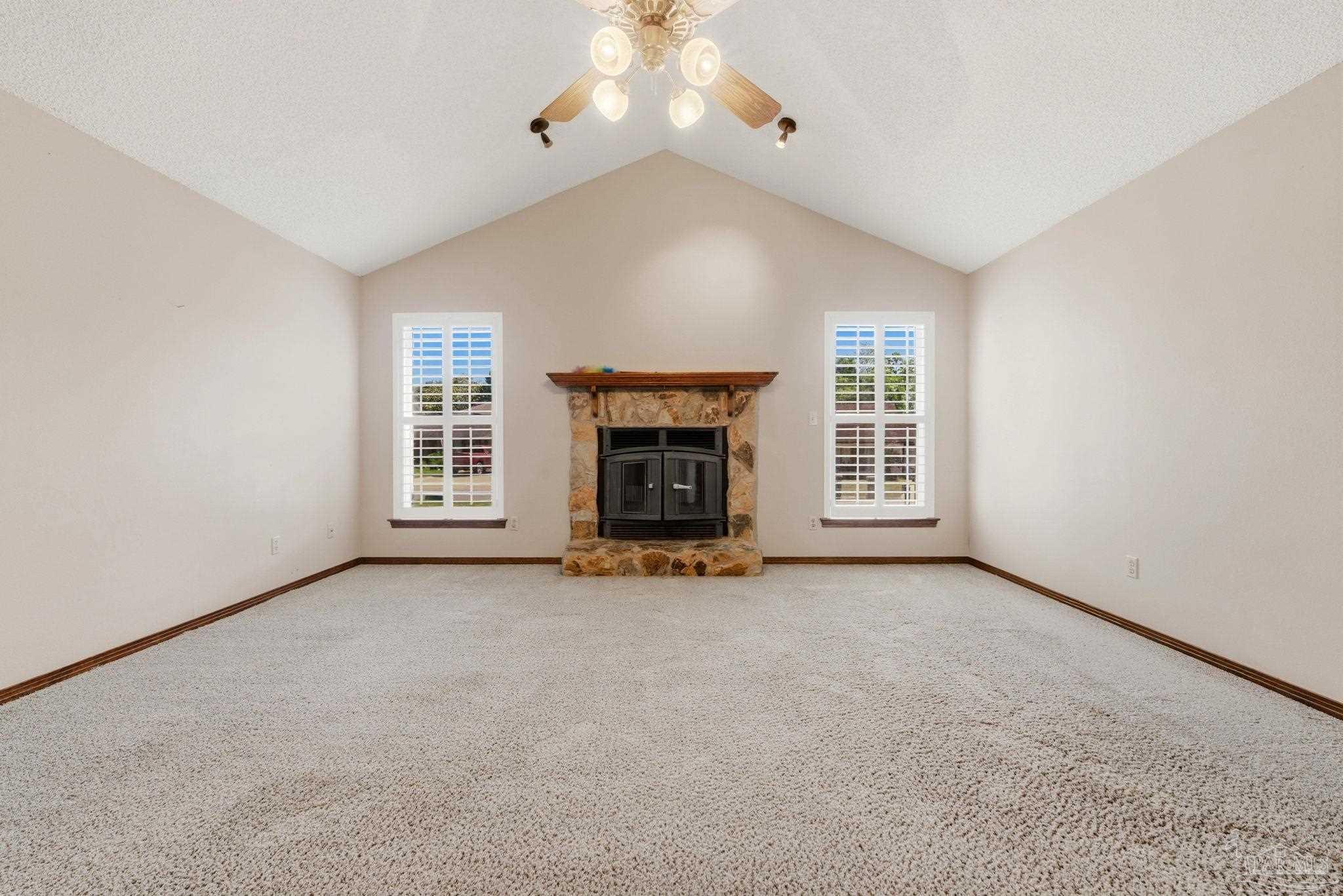 934 Springmier Place Pensacola, FL 32514 - Photo 3 of 49 an empty room with fireplace and windows