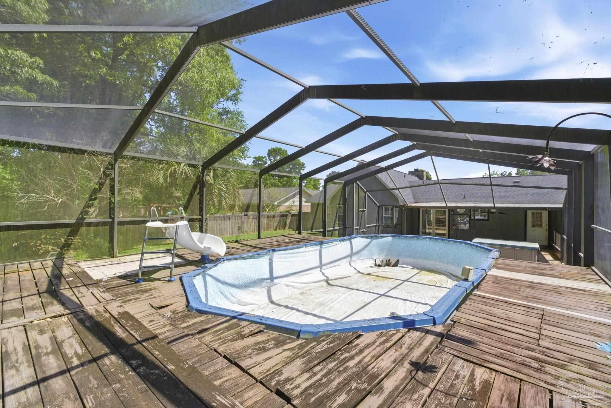 934 Springmier Place Pensacola, FL 32514 - Photo 33 of 49 a view of a patio with a dining table and chairs with wooden floor