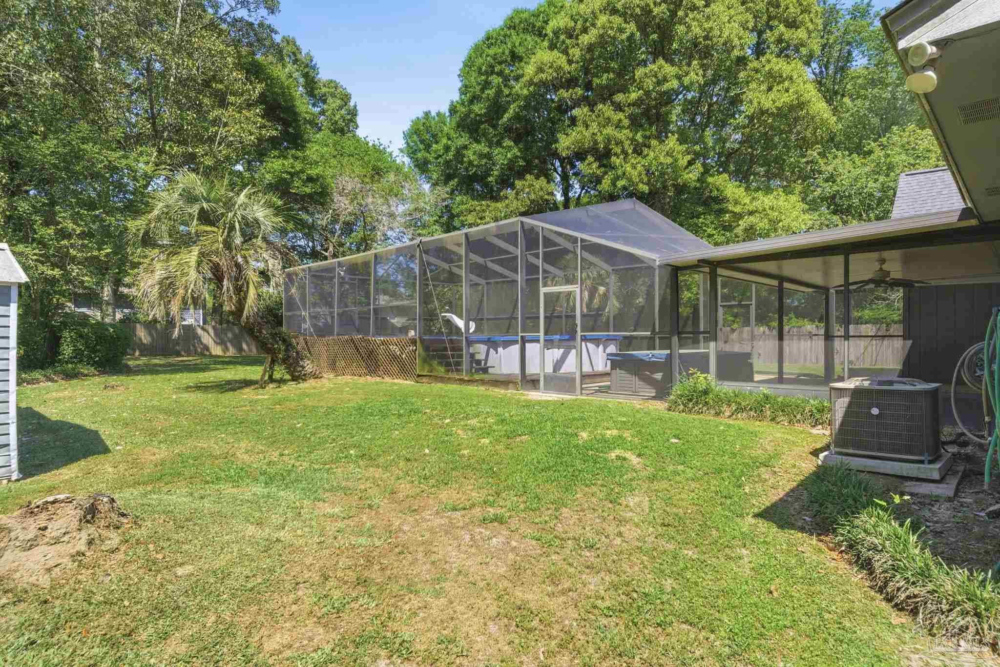 934 Springmier Place Pensacola, FL 32514 - Photo 38 of 49 a backyard of a house with yard and outdoor seating