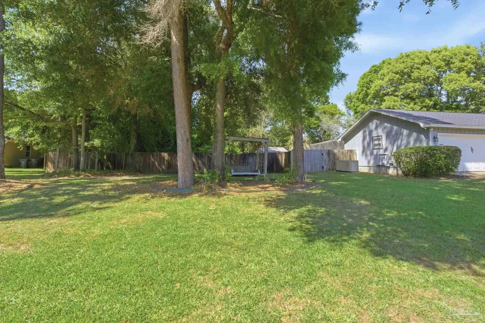 934 Springmier Place Pensacola, FL 32514 - Photo 42 of 49 a backyard of a house with lots of green space
