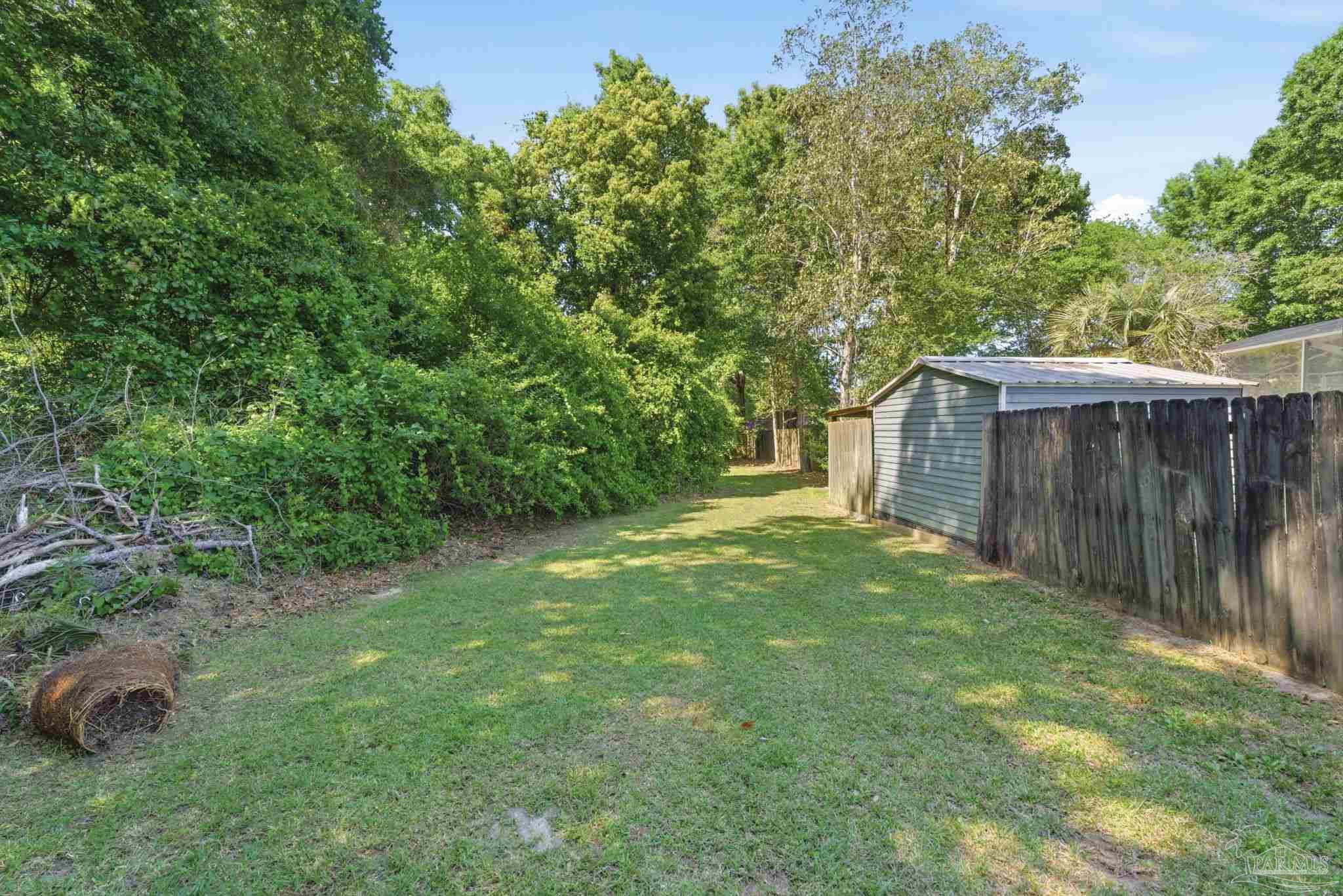 934 Springmier Place Pensacola, FL 32514 - Photo 43 of 49 a view of a backyard with barn and wooden fence