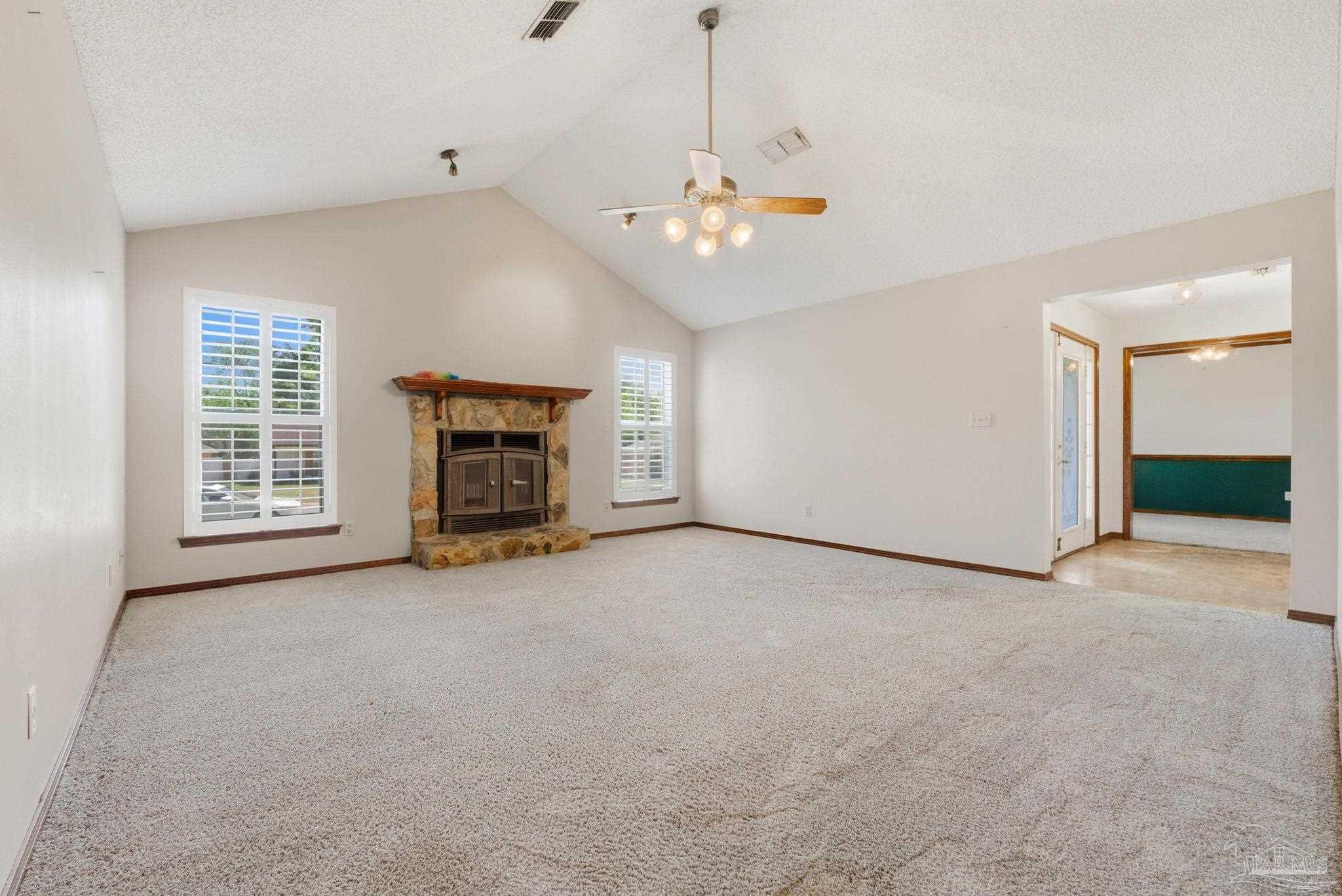 934 Springmier Place Pensacola, FL 32514 - Photo 5 of 49 an empty room with windows fireplace and cabinet