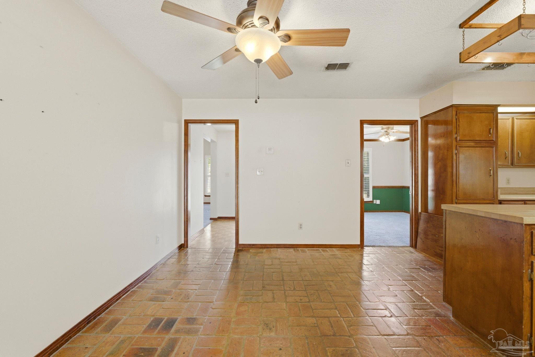 934 Springmier Place Pensacola, FL 32514 - Photo 8 of 49 a view of a refrigerator in kitchen and an empty room