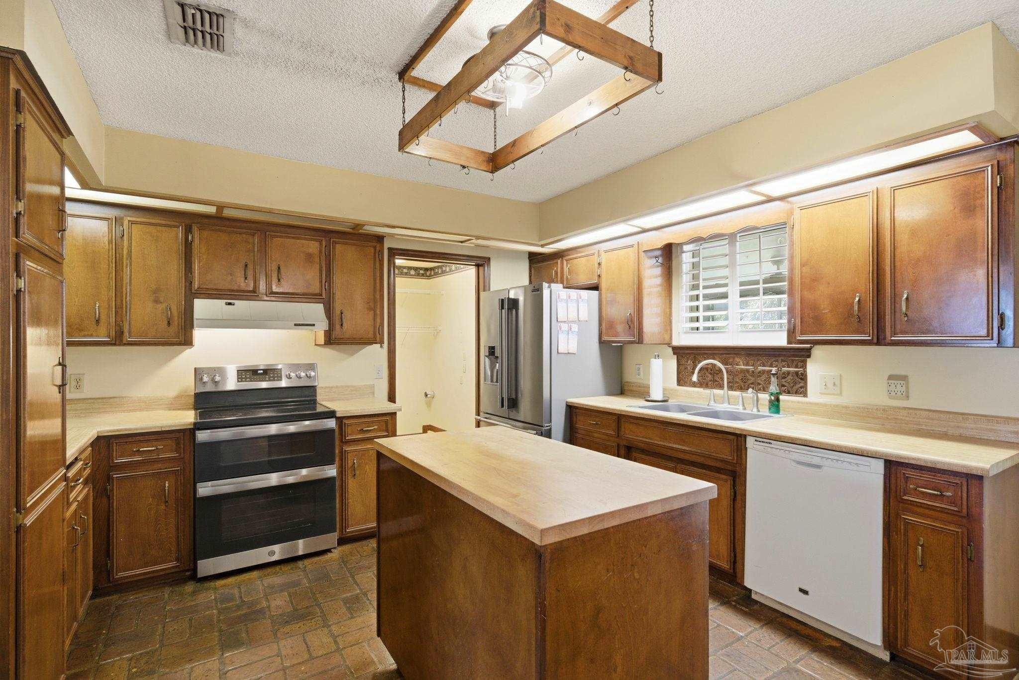 934 Springmier Place Pensacola, FL 32514 - Photo 9 of 49 a kitchen with a stove sink and cabinets