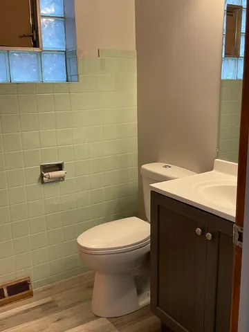 a bathroom with a sink a toilet and vanity