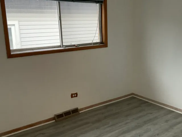 a kitchen with white cabinets and sink