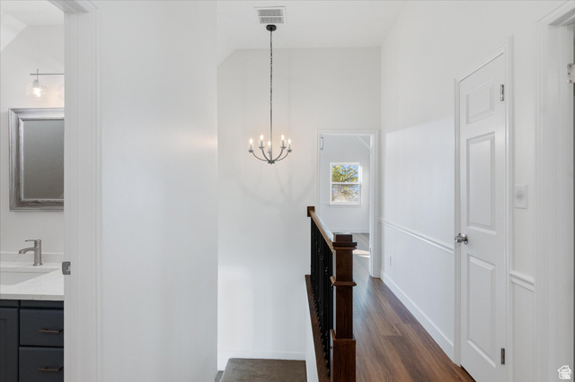 2078 Spring Oaks Drive Springville, UT 84663 - Photo 22 of 40 Hall with dark wood-style flooring, suspended lighting, and an upstairs landing