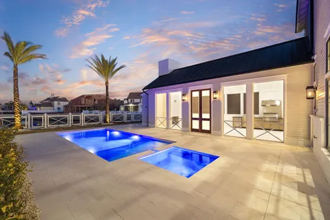 a large kitchen with stainless steel appliances granite countertop a sink a stove and a refrigerator