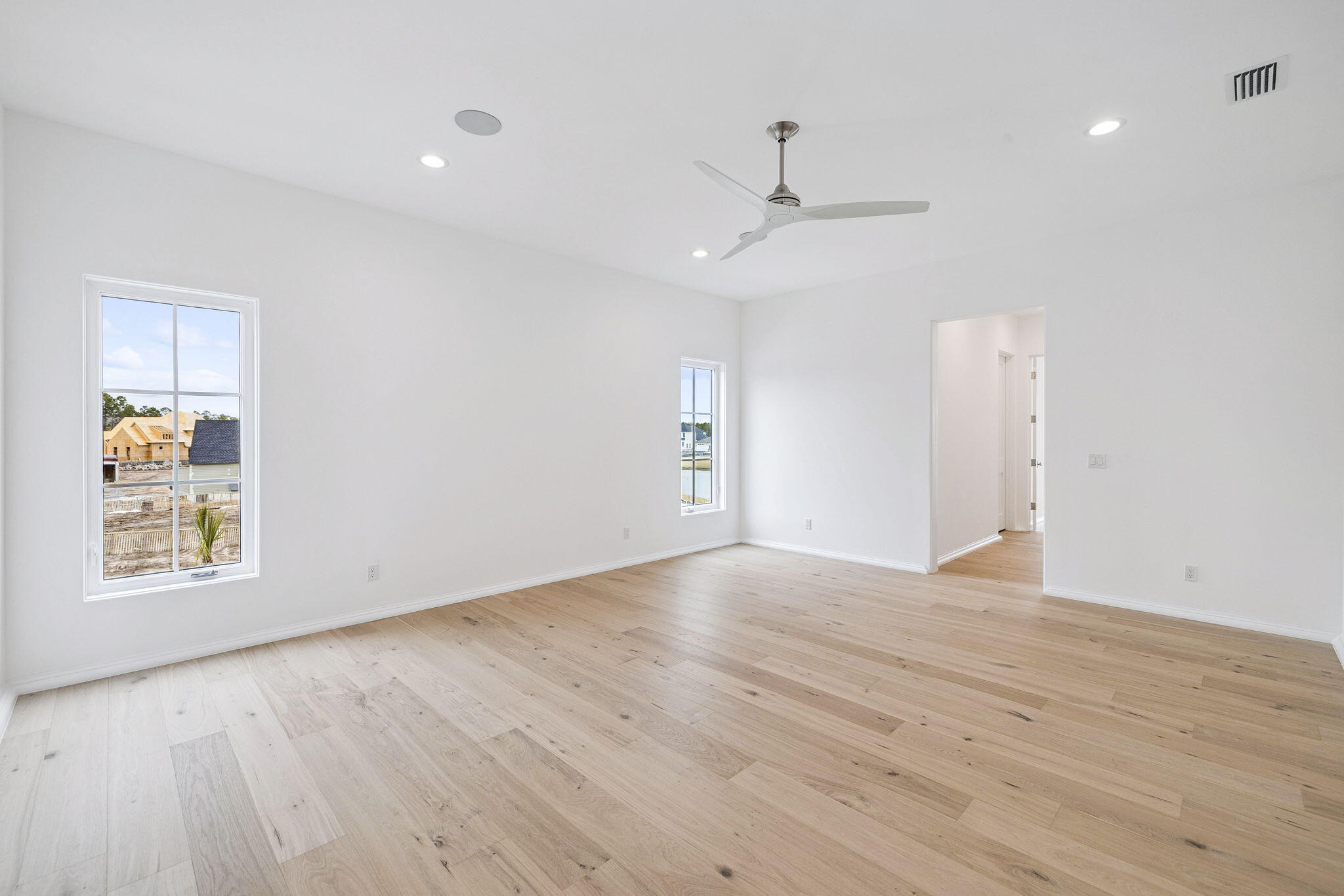 970 Windsong Dr Inlet Beach Inlet Beach, FL 32461 - Photo 39 of 78 an empty room with wooden floor ceiling fan and windows