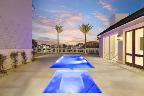 a swimming pool with outdoor seating and yard