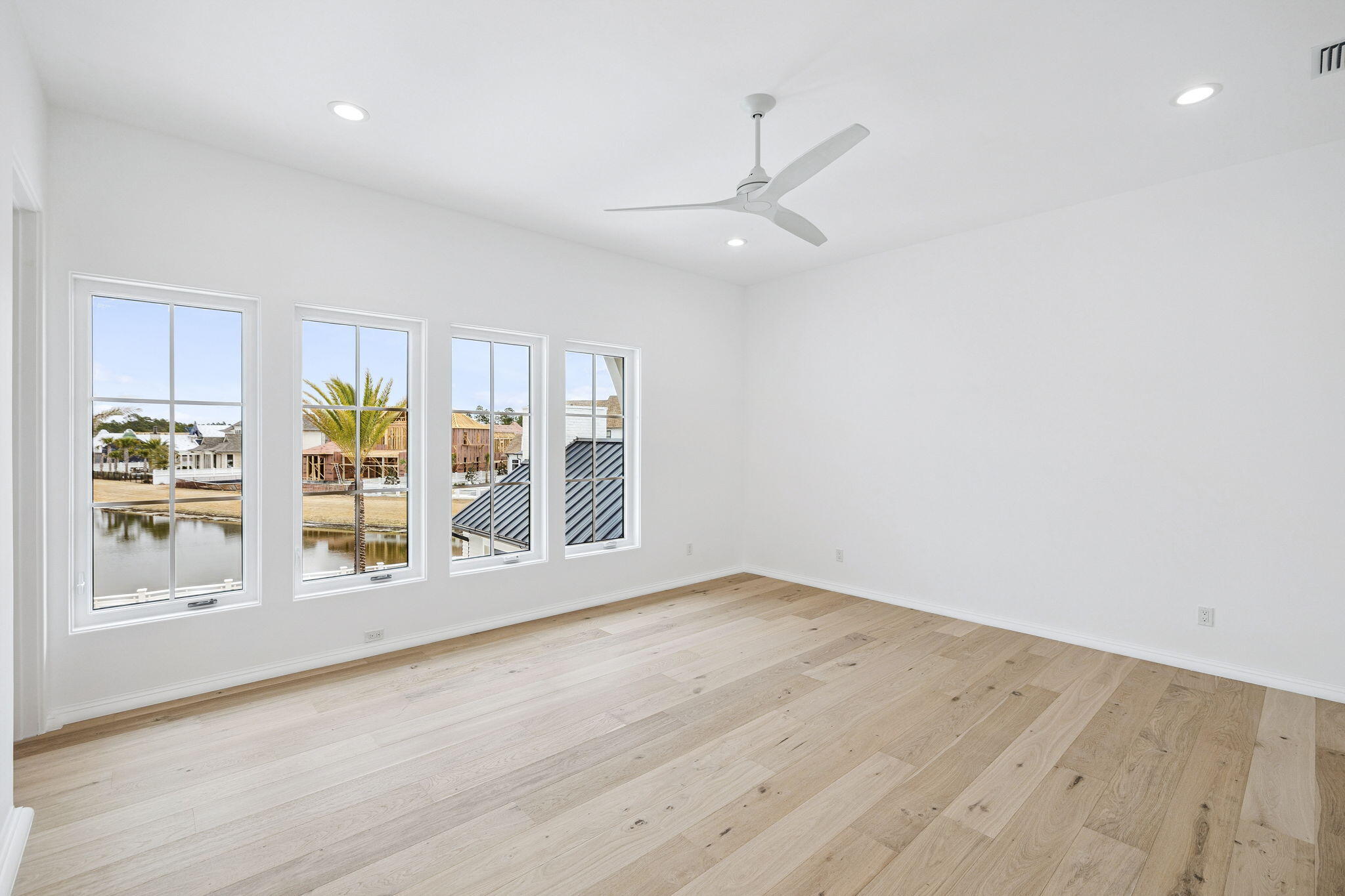 970 Windsong Dr Inlet Beach Inlet Beach, FL 32461 - Photo 48 of 78 an empty room with wooden floor and windows