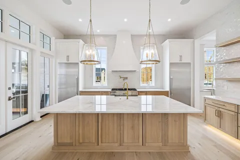 a kitchen with stainless steel appliances a stove a sink and a refrigerator