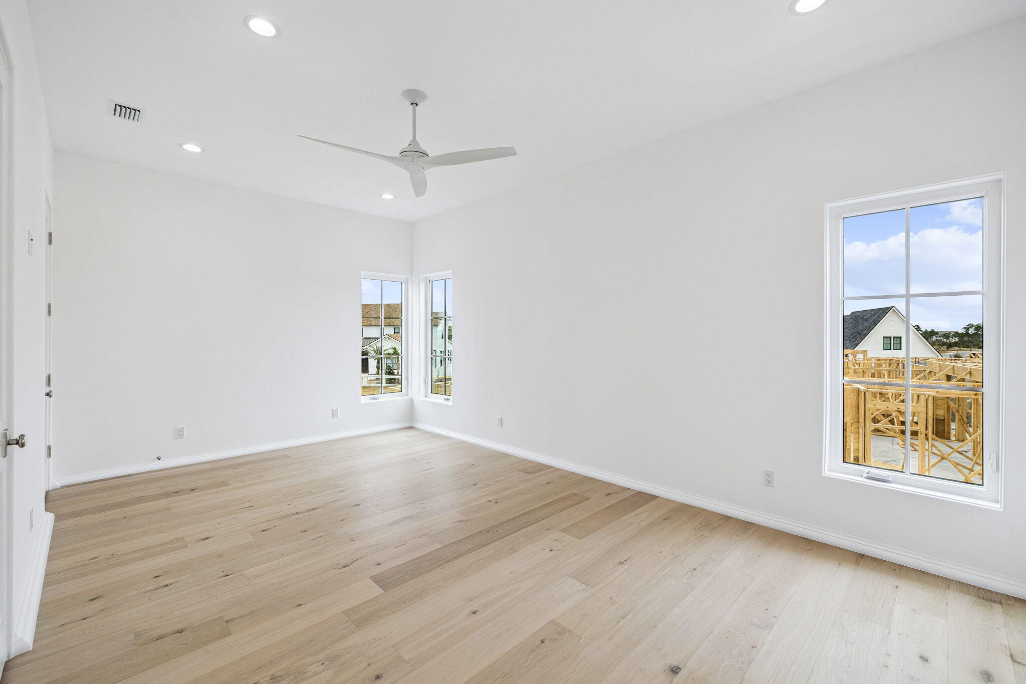 970 Windsong Dr Inlet Beach Inlet Beach, FL 32461 - Photo 51 of 78 an empty room with wooden floor ceiling fan and windows