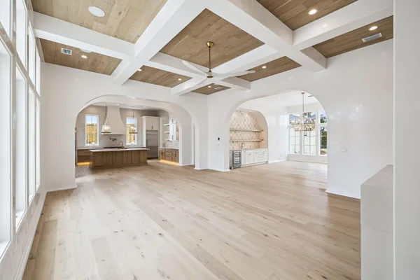 a large kitchen with stainless steel appliances granite countertop a sink a stove and a refrigerator