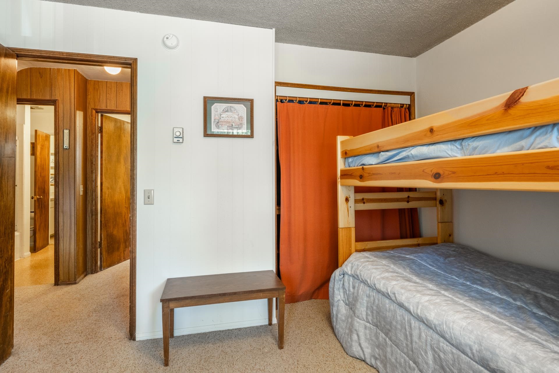 50 Hidden Valley Road, Unit 17 Mammoth Lakes, CA 93546 - Photo 25 of 40 Carpeted room featuring natural wood bunk beds, an interior hallway with wood paneling and multiple
