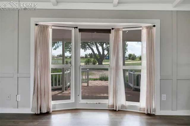 a view of front door with wooden floor