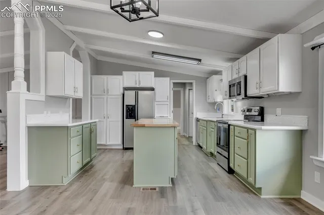 a kitchen with stove and cabinets