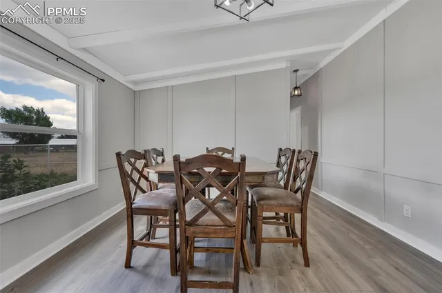 a view of a dining room with furniture and wooden floor