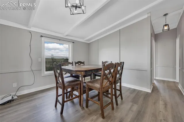 a view of a dining room with furniture and wooden floor