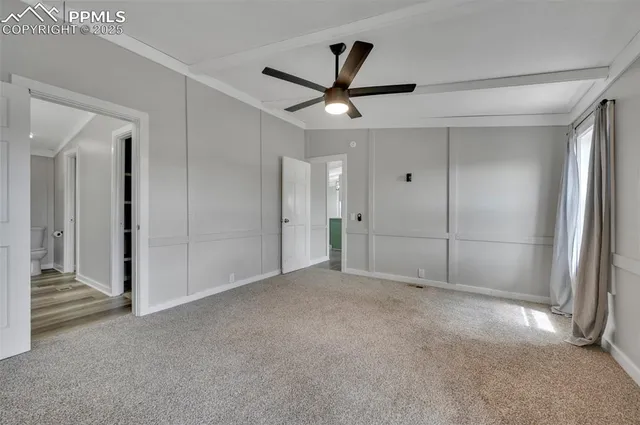 a view of an empty room and a ceiling fan