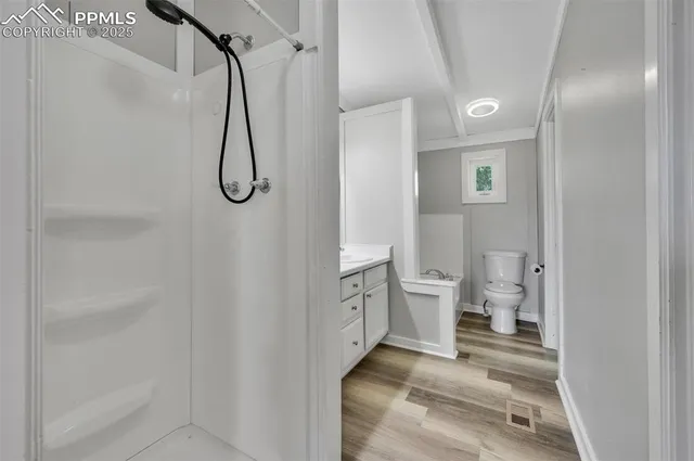 a bathroom with a toilet sink and shower