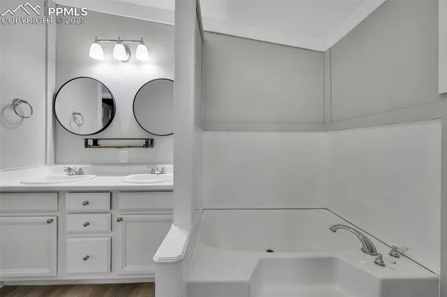 a bathroom with a sink vanity and mirror