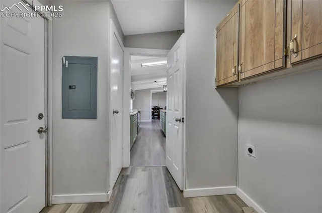 a view of a hallway with wooden floor