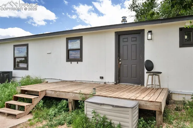 a backyard of a house with outdoor seating
