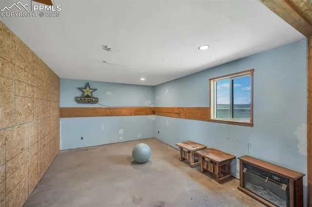 a room with a chair and potted plant on a table