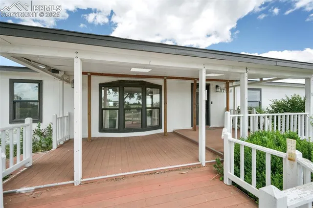 a view of porch with a black gate