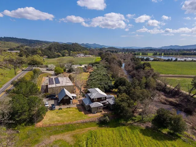 a aerial view of a house with swimming pool table and chairs