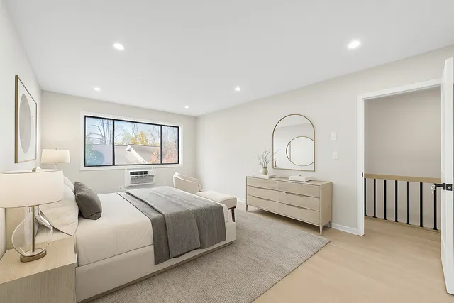 a bedroom with bed and a large window