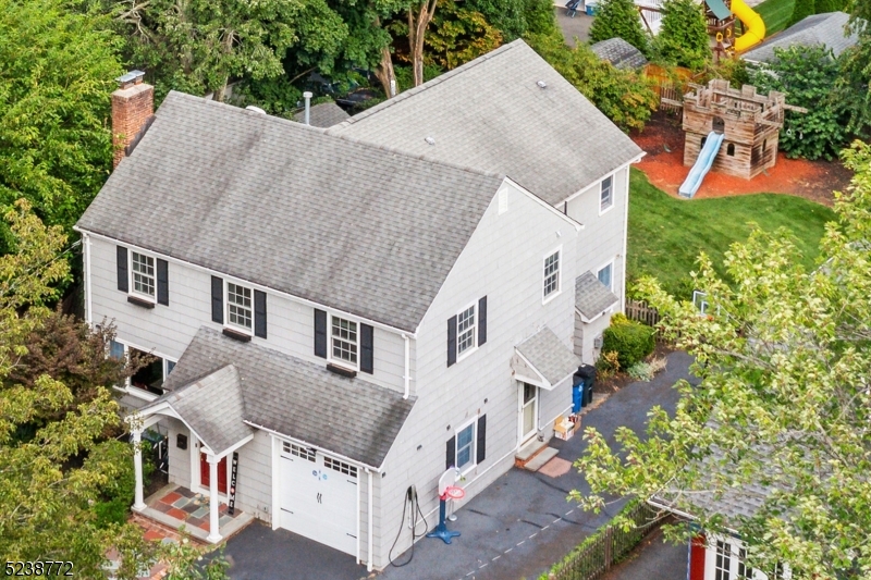 an aerial view of a house with roof deck and garden