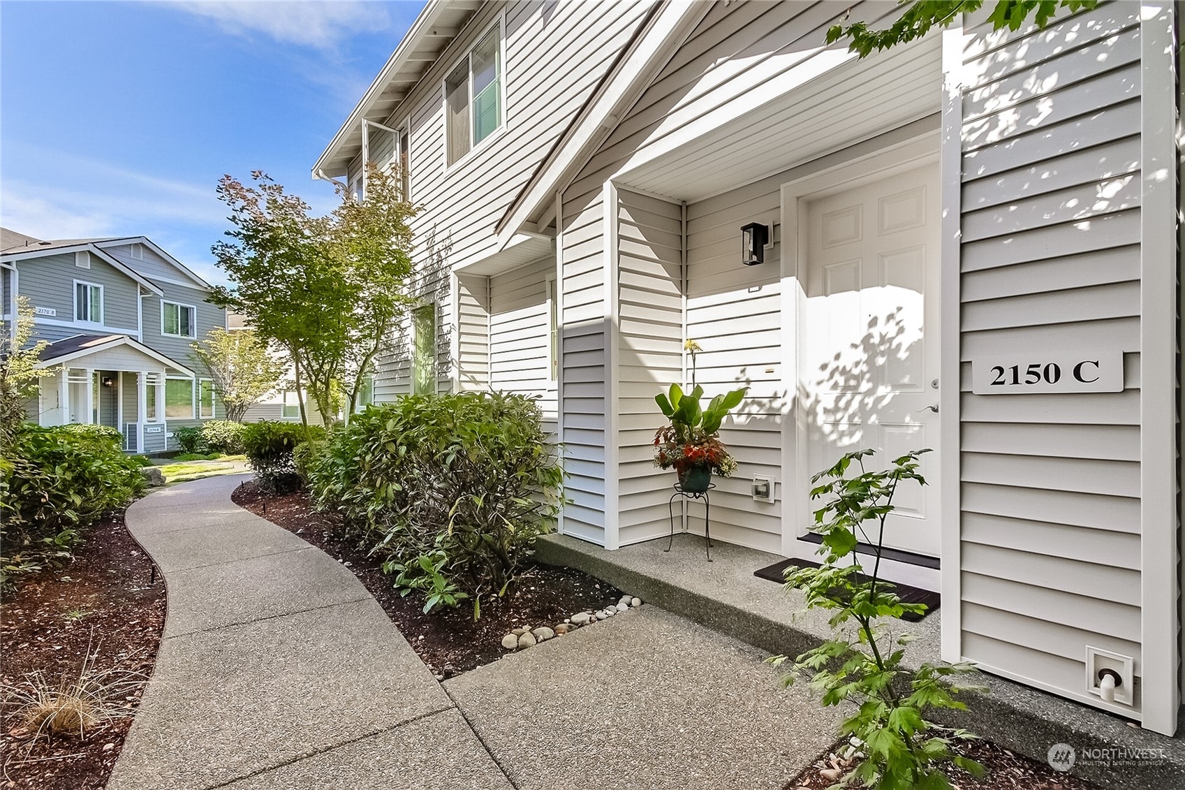 2150 Charles Street, Unit C DuPont, WA 98327 - Photo 1 of 18 a front view of a house with a garden