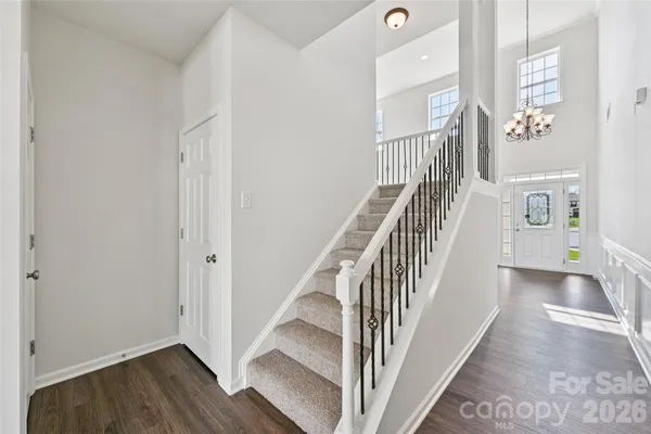 a view of a hallway with wooden floor and entryway