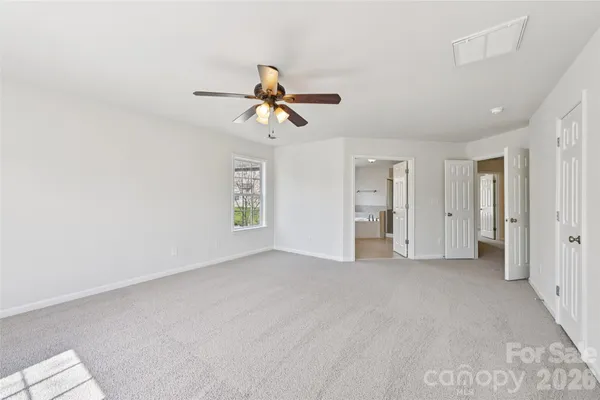 a view of empty room with ceiling fan