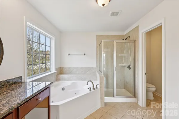 a bathroom with a tub sink and shower