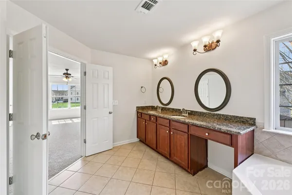 a room with round mirror and a sink