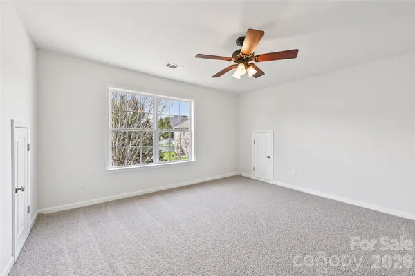 a view of room with window and ceiling fan