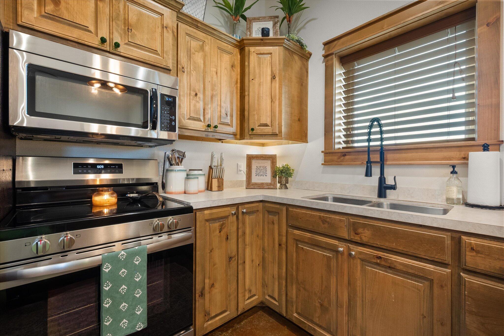 753 Co Road Plainview, TX 79072 - Photo 11 of 39 a kitchen with stainless steel appliances granite countertop a sink a stove and microwave