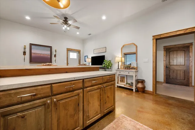 a bedroom with a bed and a flat tv screen on the dresser