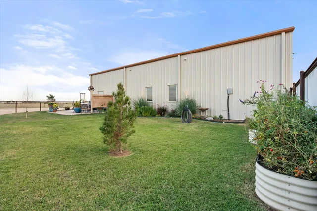 a view of a garden with a bench in the background
