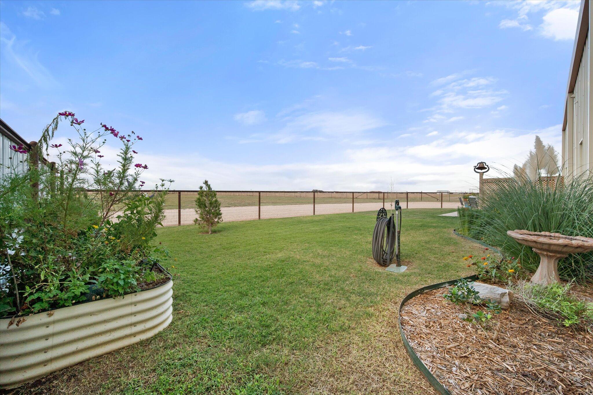 753 Co Road Plainview, TX 79072 - Photo 28 of 39 a view of a garden with a bench in the background