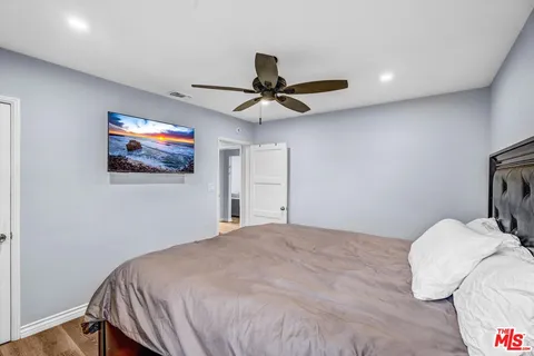 a bedroom with a bed and a chandelier