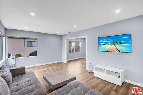a living room with furniture and wooden floor