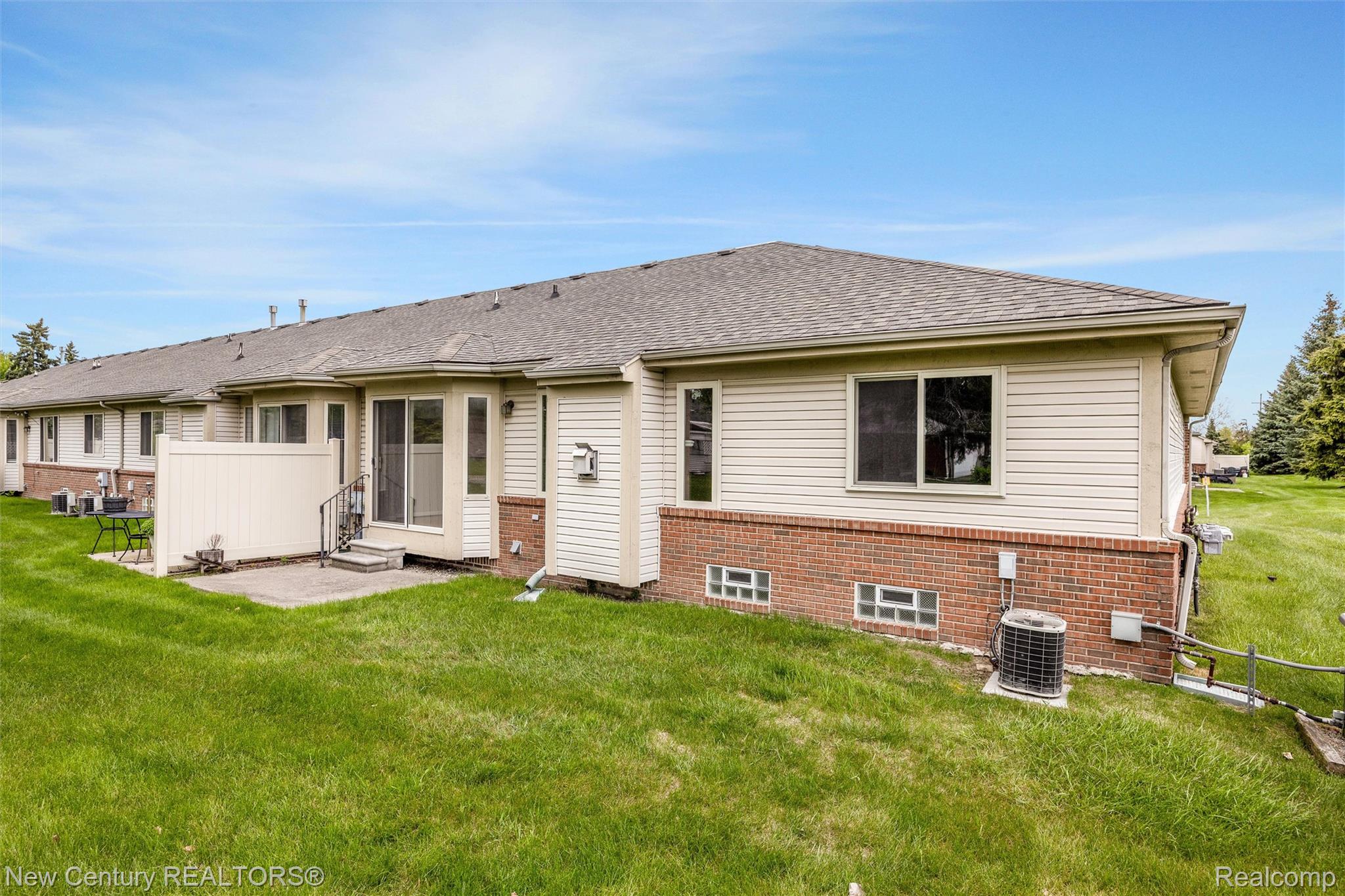 26013 Ranger Avenue Warren, MI 48091 - Photo 23 of 25 Rear view of house featuring a lawn, brick siding, a shingled roof, and a patio area
