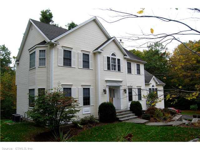 79 Hemlock Ridge Road Southbury, CT 06488 - Photo 1 of 1 a front view of a house with a yard and garage